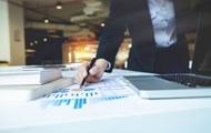 A man pointing on a report